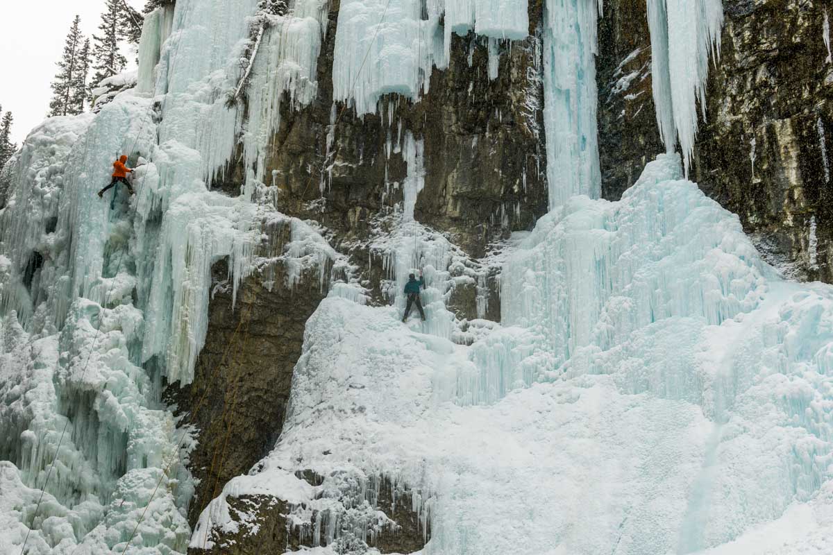 Two people ice climb in Johnston Canyon