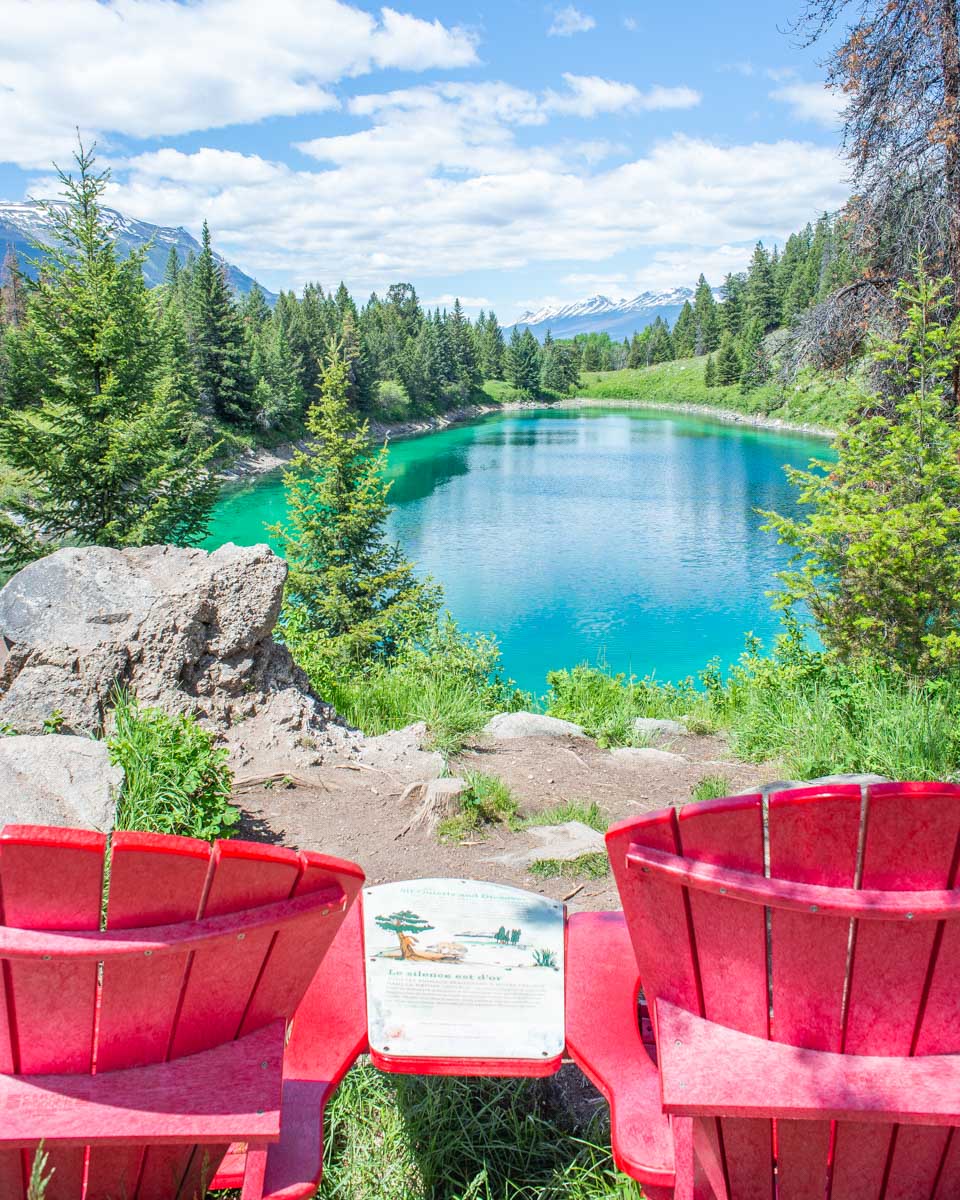 Two red chairs in the Valley of the 5 Lakes near Jasper, Canada