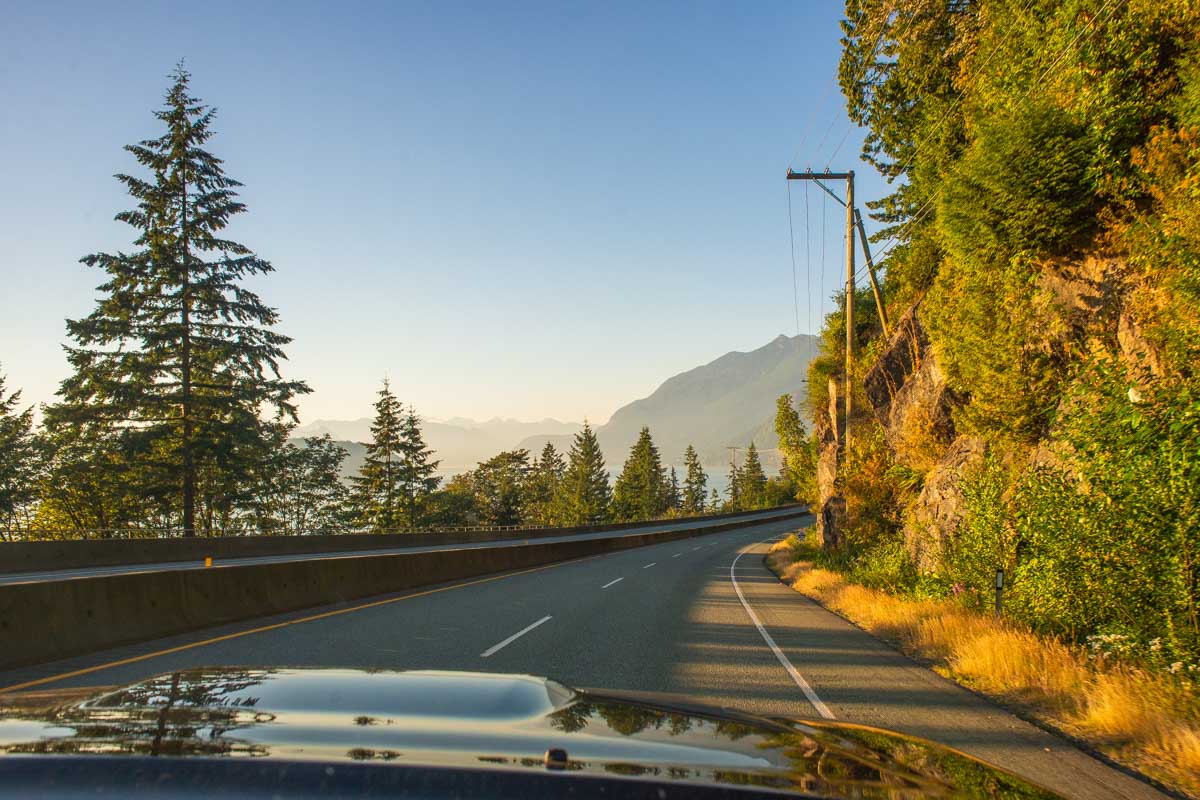 View out the windscreen of a car on the Sea to Sky Highway at sunset
