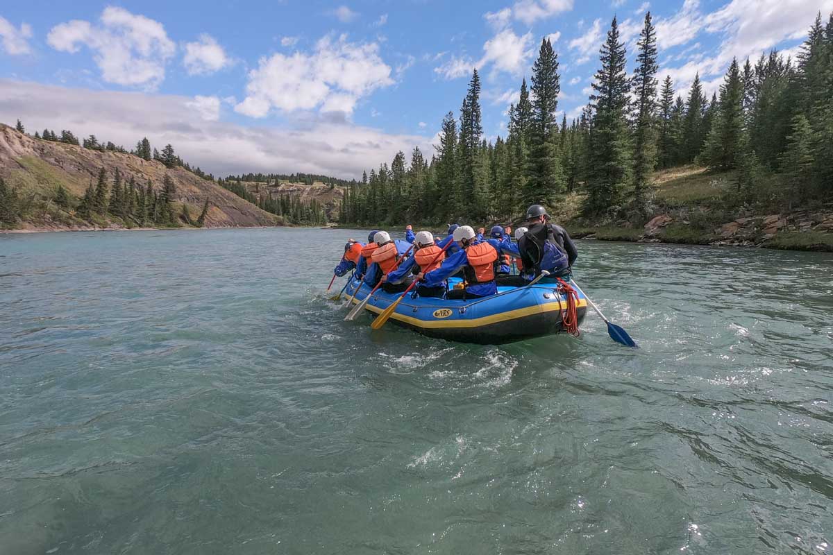 A raft floats down the river to the next rapid in Banff