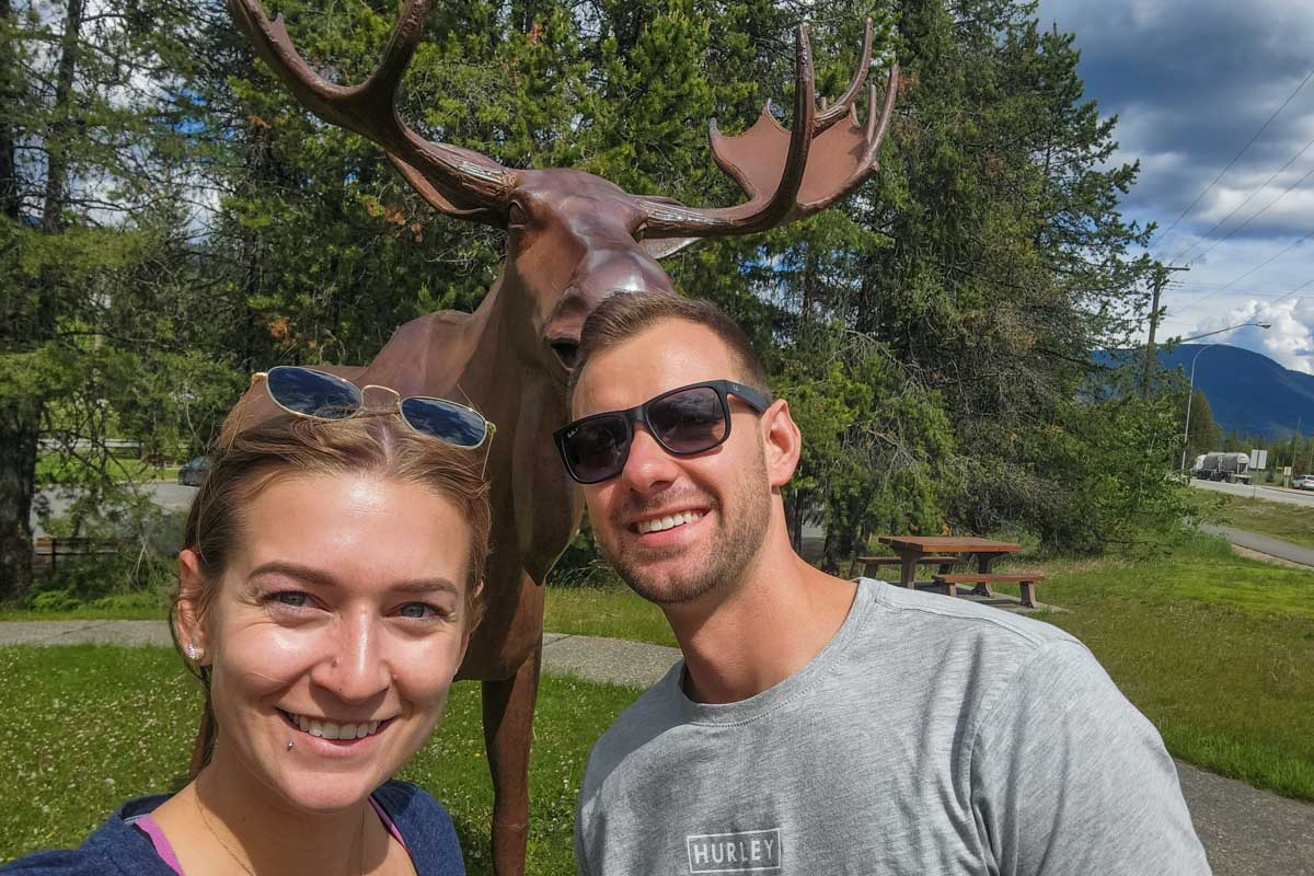Bailey and Daniel take a selfie in front of the moose statue at the Wells Gray Provincial Park visitor center