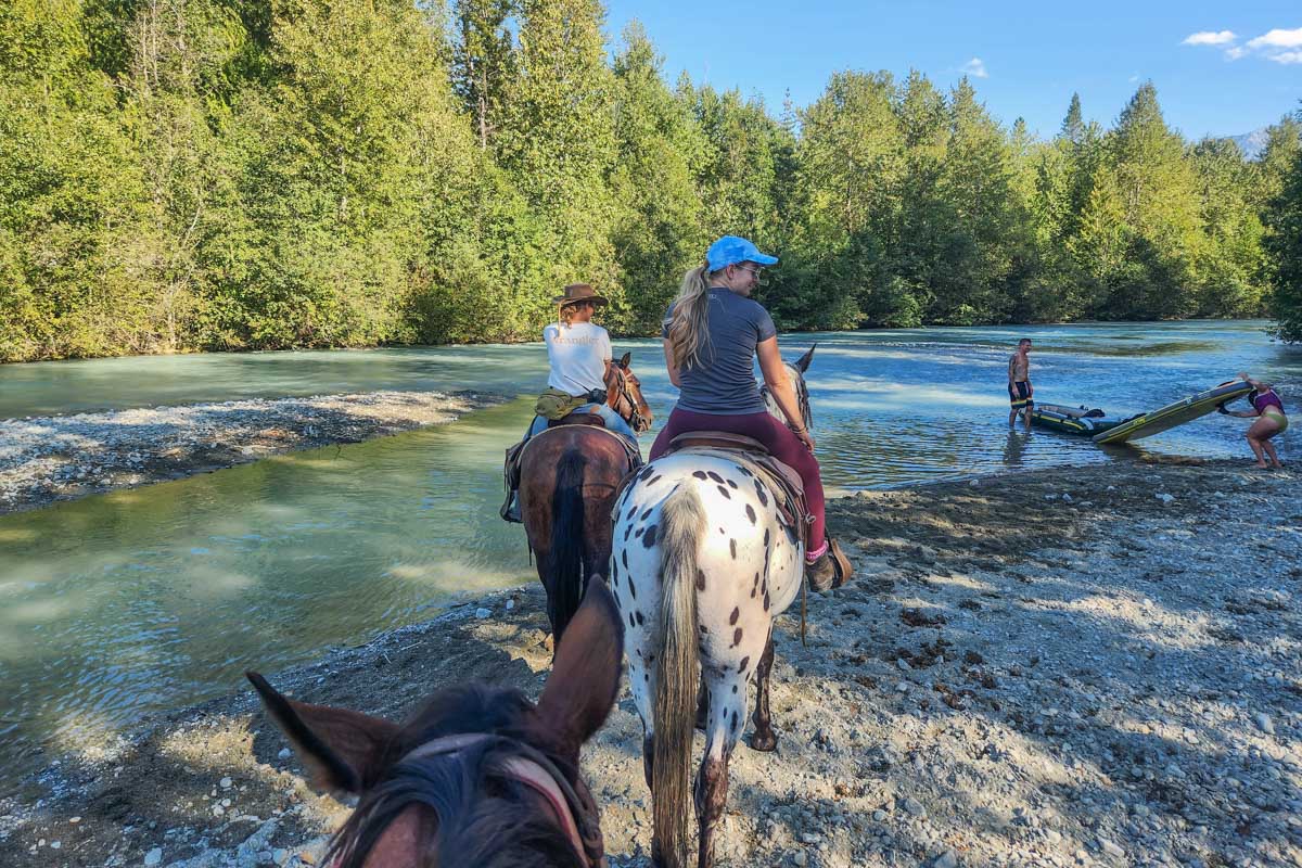 Entering the Bow River on a horseback riding tour in Banff