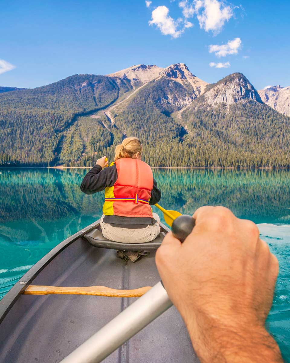 Two people canoe on Emerald Lake in Yoho National Park, Canada