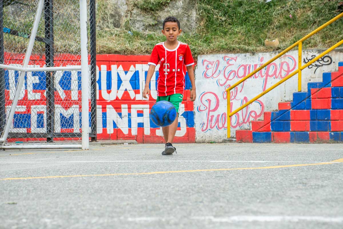 A boy plays basketball in Comuna 13, Medellin