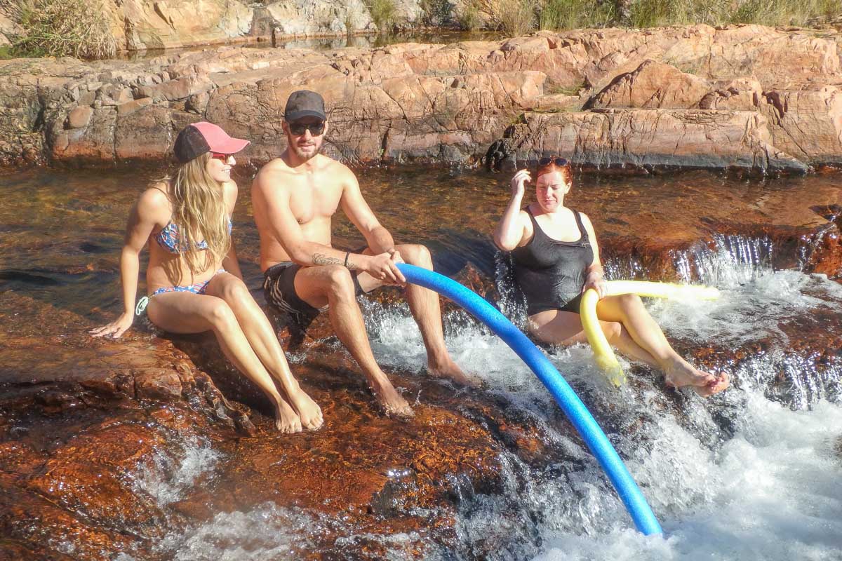 A groupd of people at walker creek in Litchfield National Park