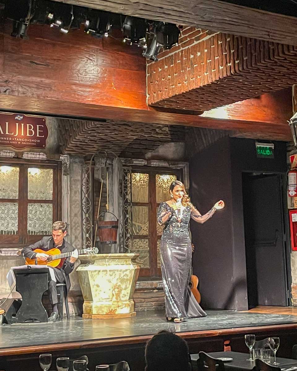 A lady sings on stage at a tango show in Buenos Aires