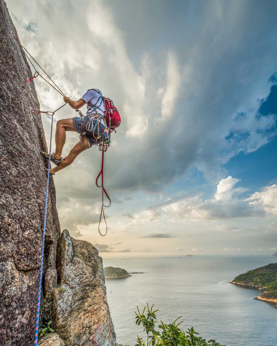 A man rock climbing on Sugarloaf Mountain (Pão de Açúcar) in Rio de Janeiro, Brazil