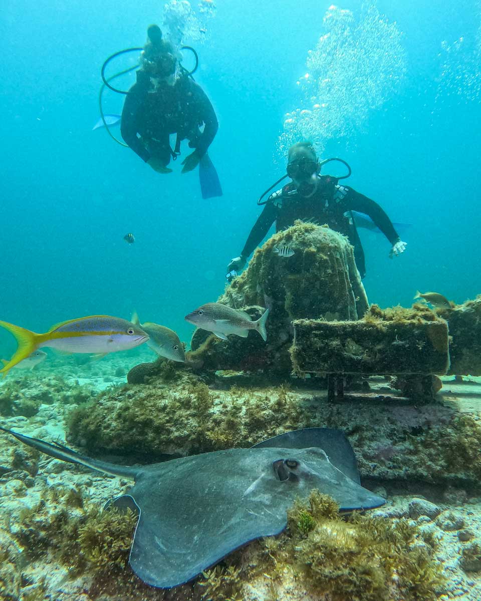 Bailey and Daniel look at a Sting Ray at the MUSA dive site in Cancun