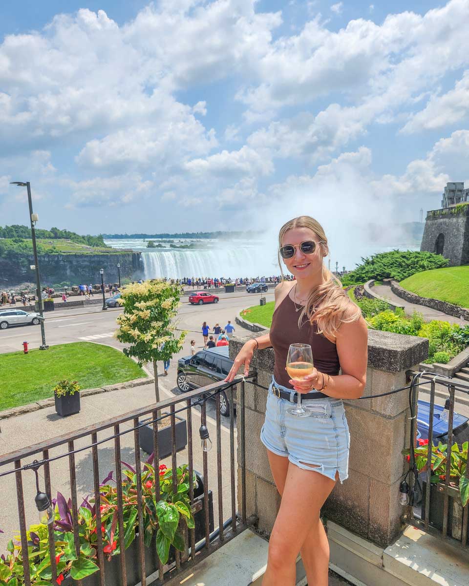 Bailey enjoys a glass of wine at Queen Victoria Place Restaurant with views of Niagara Falls