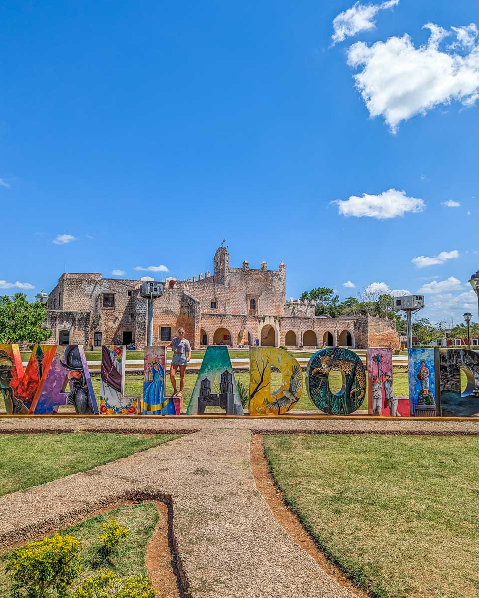 Bailey poses for a photo with the Valladolid sign in Valladolid, Mexico