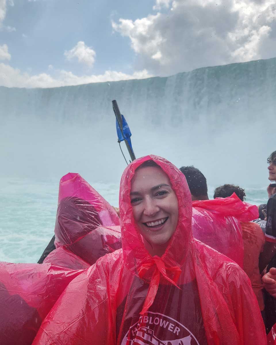 Bailey smiles at the camera while getting wet at the base of Niagara Falls on the Hornblower Cruise