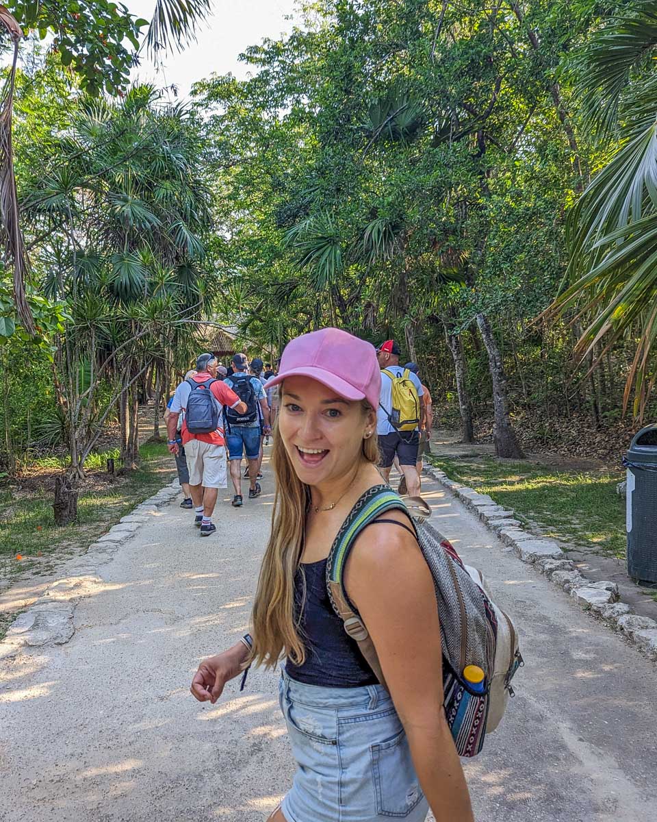 Bailey smiles at the camera while walking through the entrance of the Tulum Ruins, Mexico