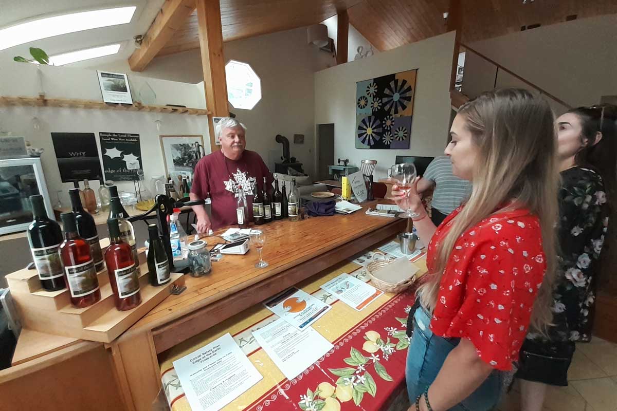 Bailey tastes wine at Edge of the Earth winery