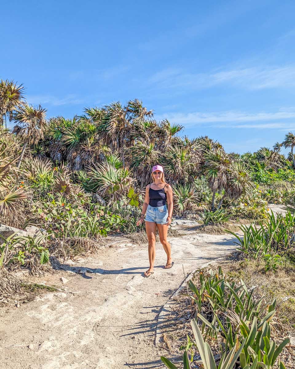 Bailey walks along a dirt path at the Tulum Ruins in Mexico