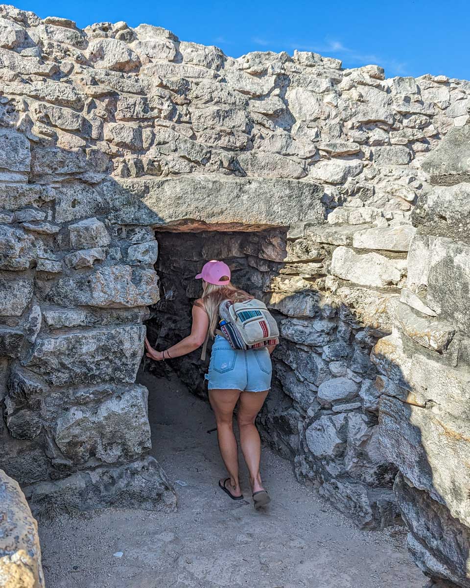 Bailey walks through a tunel building at the Tulum Ruins in Tulum, Mexico