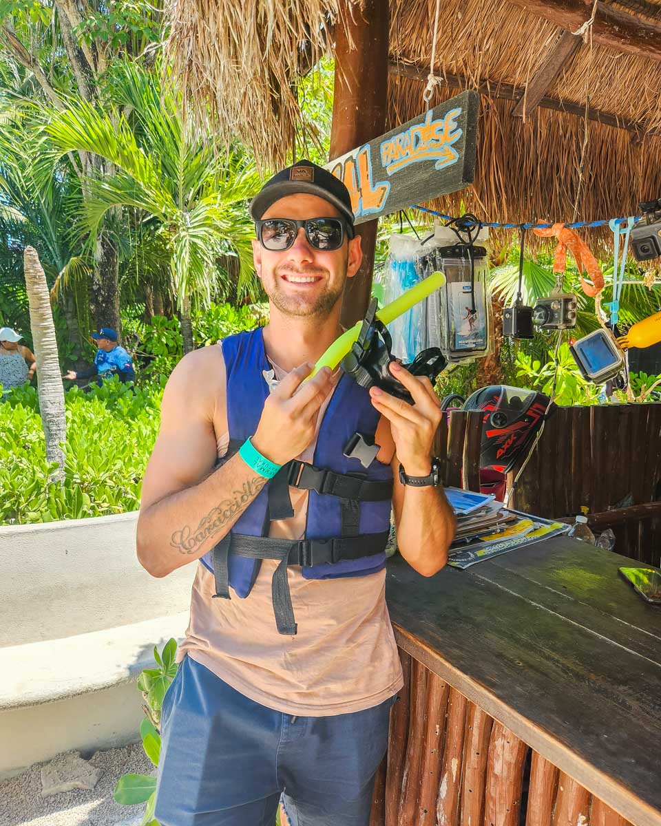 Daniel gets his snorkel and life jacket before going on a tour at Akumal Beach