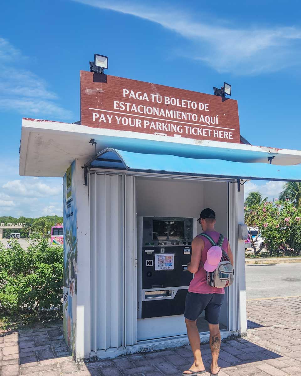 Daniel pays for his parking at the Tulum Ruins in Tulum, Mexico