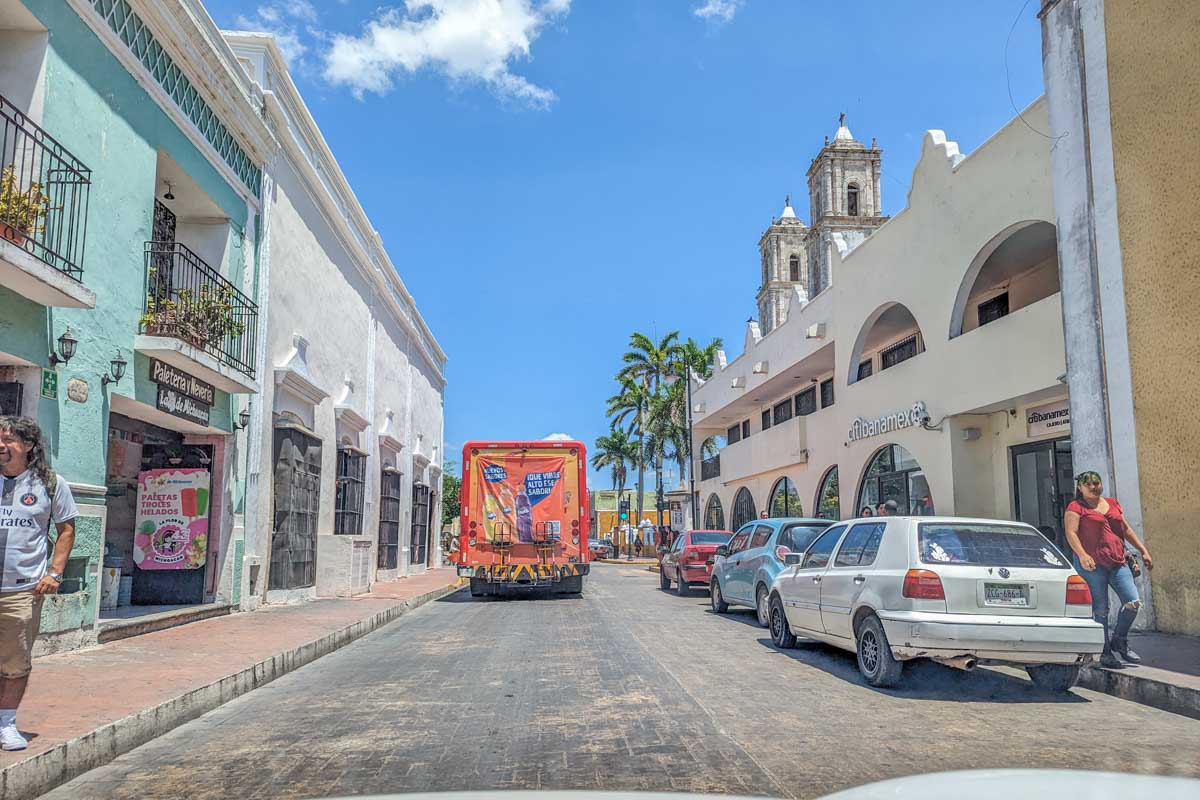 Driving a rental car along a cute colonial street in Bacalar, Mexico