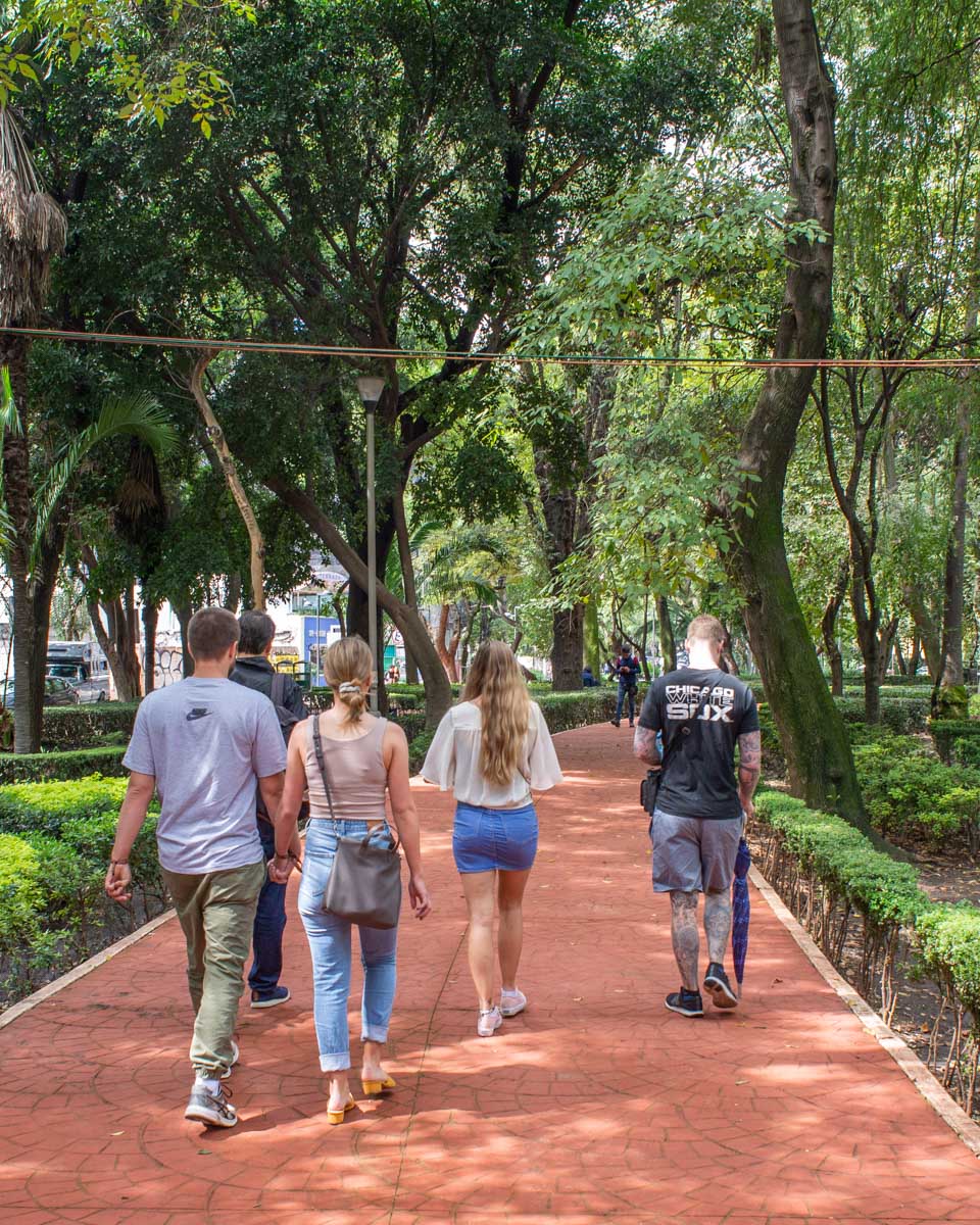 A group of tourists follow their guide around Mexico City on a taco tour