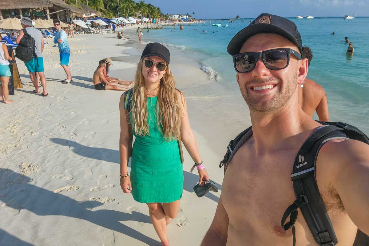 Bailey and Daniel take a selfie while walking on a beach on Isla Mujeres