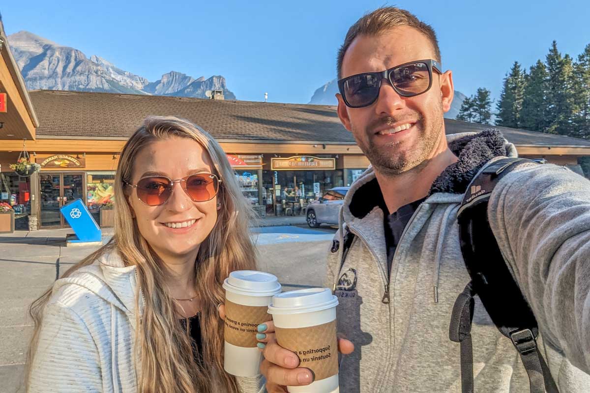 Bailey and Daniel take a selfie with coffees from Laggins Bakery in Lake Louise