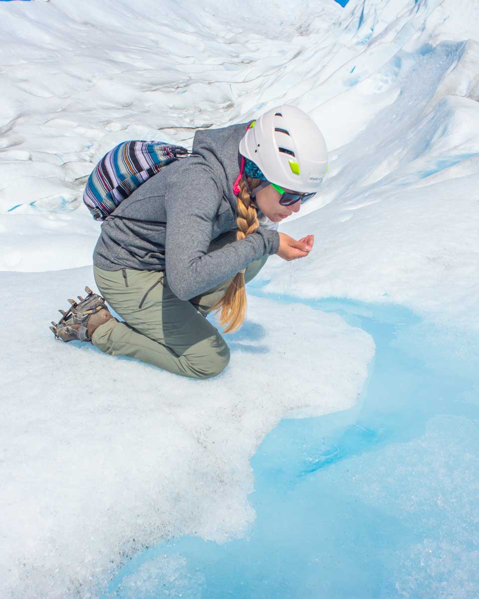 Bailey drinks glacier water from a stream on the Perito Moreno Glacier Mini trekking tour