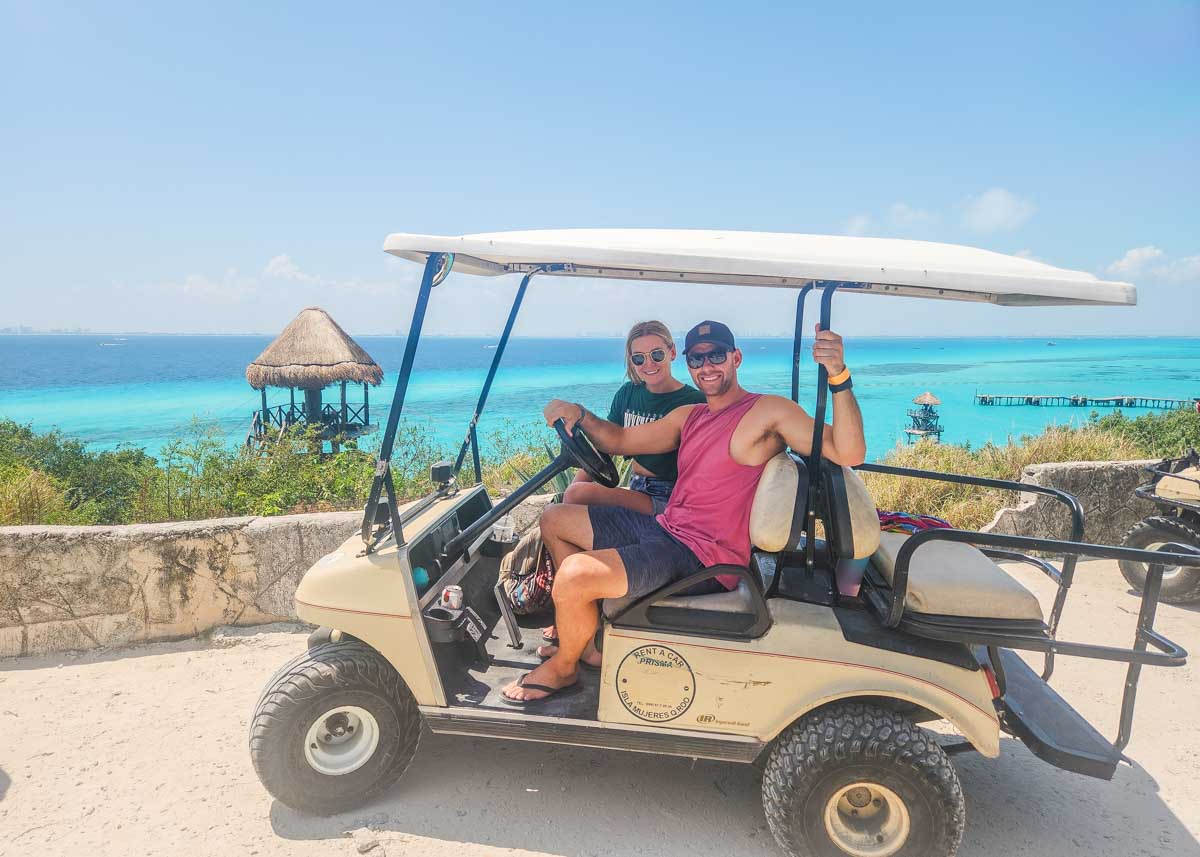 Daniel and Bailey sit in their rented golf cart on Isla Mujeres, Mexico
