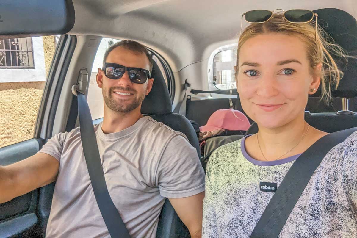 Daniel and Bailey take a selfie inside their rental car in Argentina