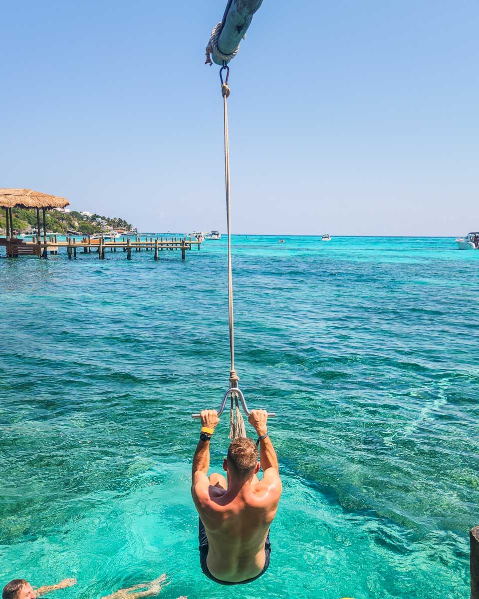 Daniel on a rope swing at Kin Há Isla Mujeres