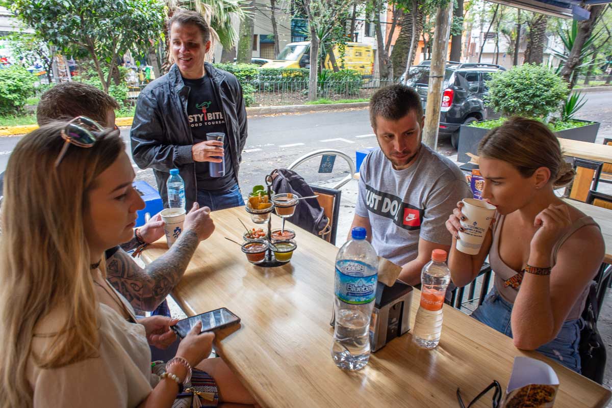 Our tour group sit at a table ready to try tacos in Mexico City