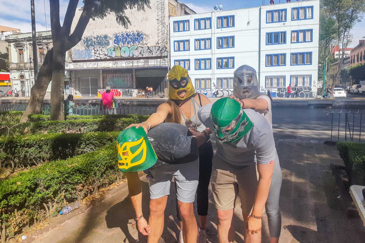 Our tour groupd with our Lucha Libre masks on posing for a photo in Mexico City before the show