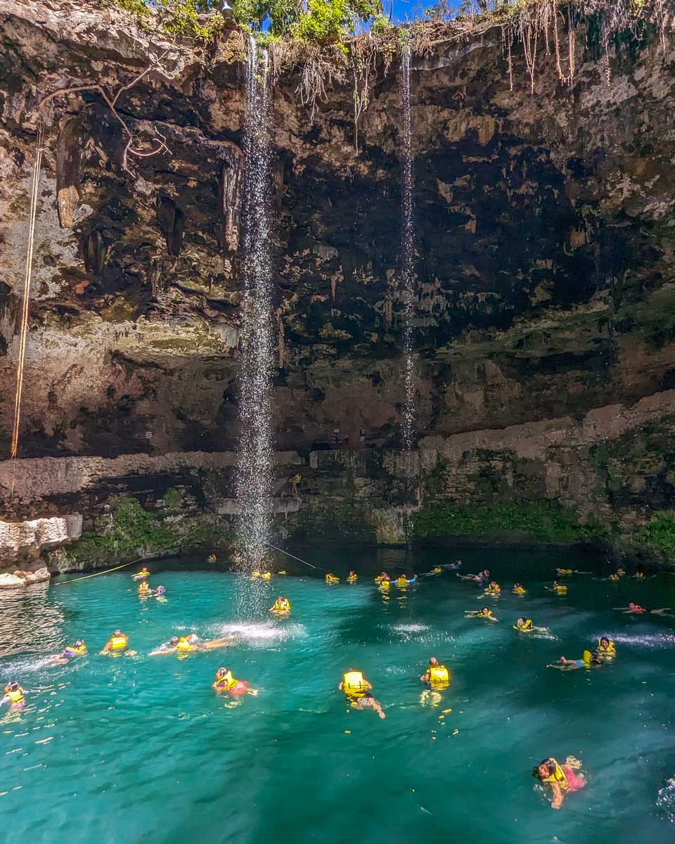 People swim in Saamal Cenote, Mexico