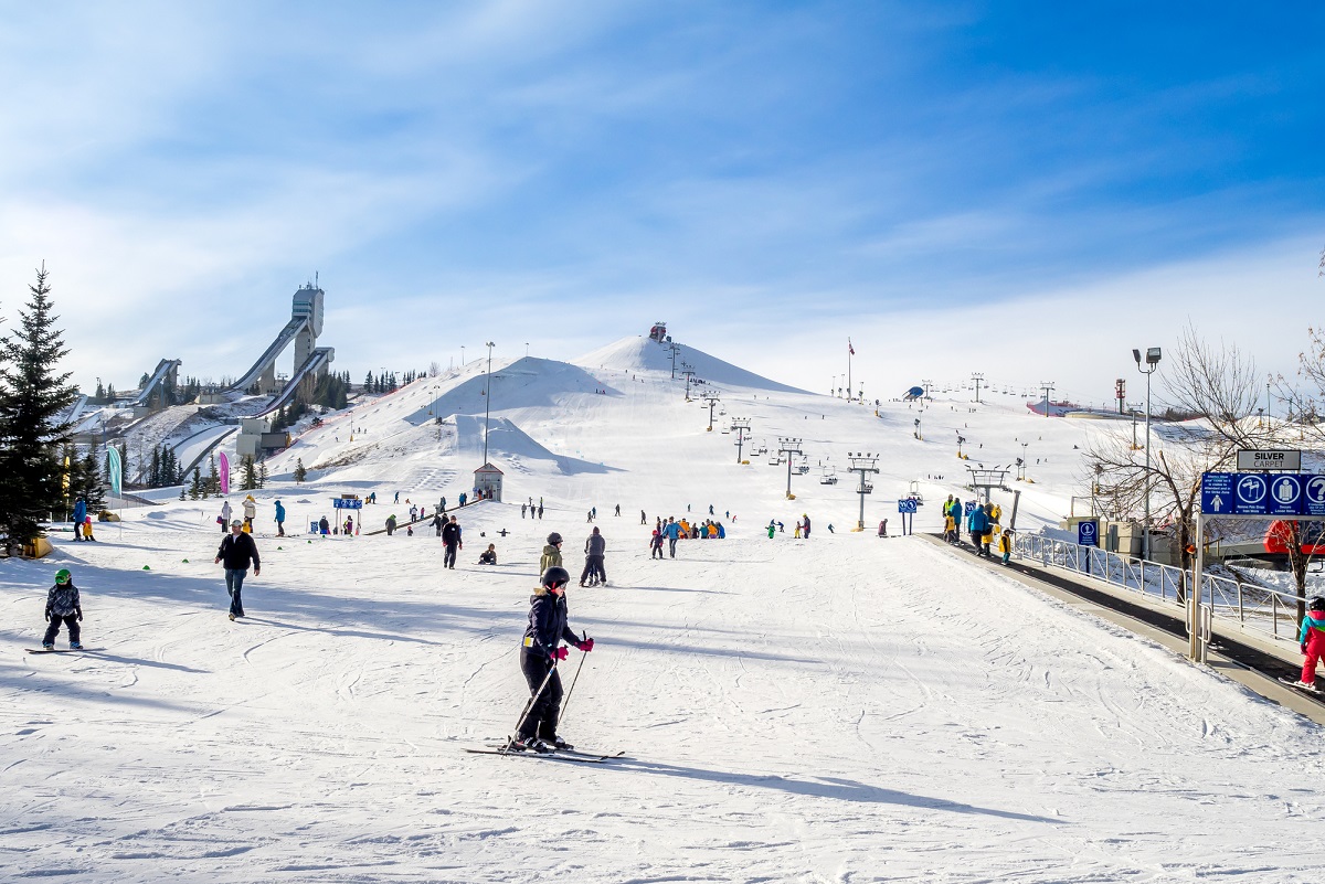 People skiing at Olympic Park in Calgary on a sunny winter day
