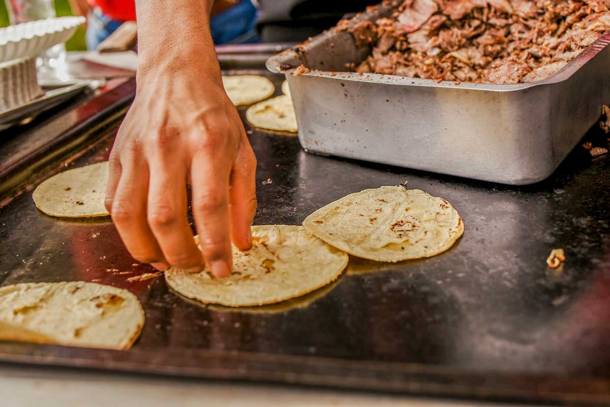 A man cooks torillas in Cancun, Mexico