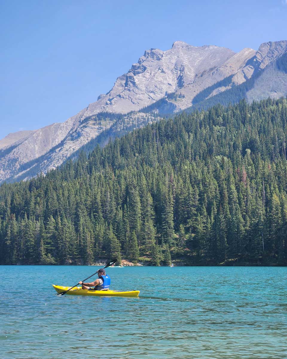 A person kayaks on Two Jack Lake in Banff National Park