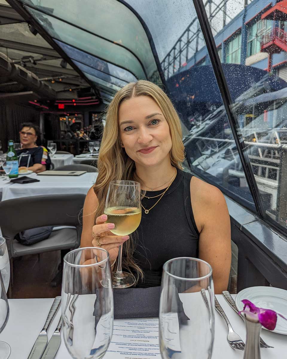 Bailey enjoys a glass of wine onboard the Bateaux New York Premier Dinner Cruise