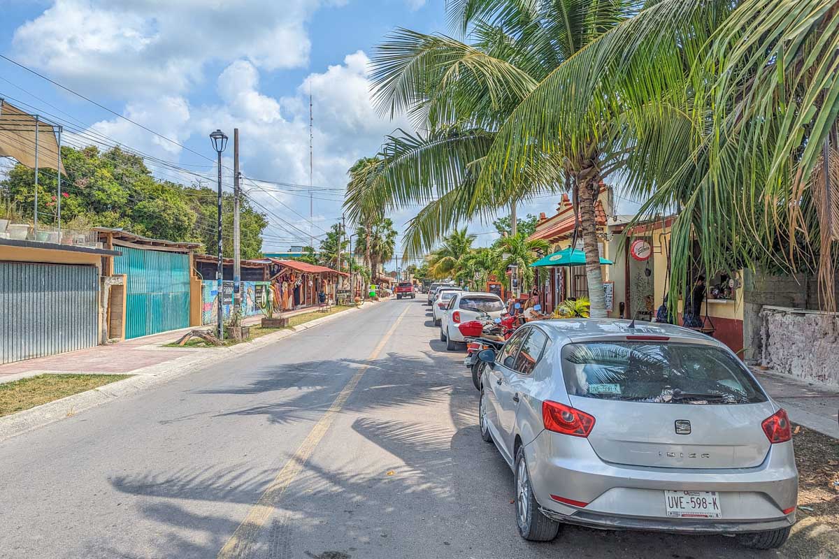 Cute colonial street in Mexico with a parked rental car