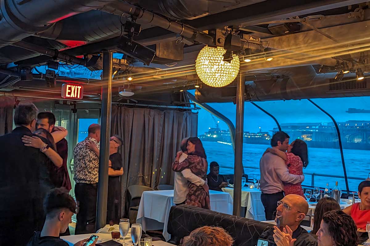 People dance onboard the Bateaux New York Premier Dinner Cruise
