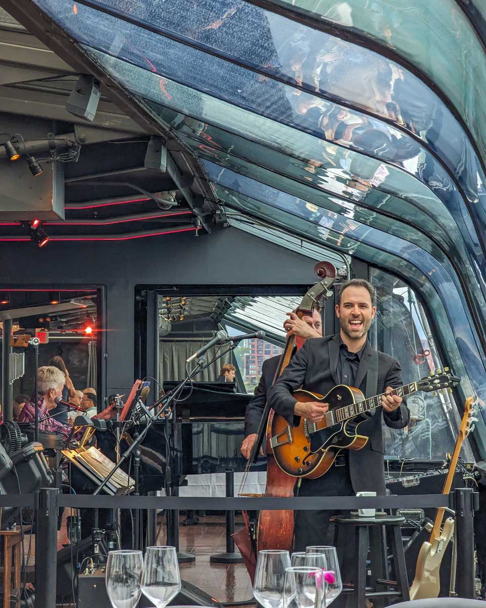 The band play music on the Bateaux New York Premier Dinner Cruise