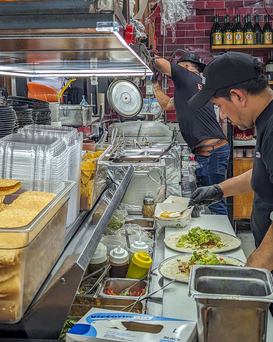 A man cooks our Japanese inspired tacos in the Chelsea Market on our food tour in New York CIty