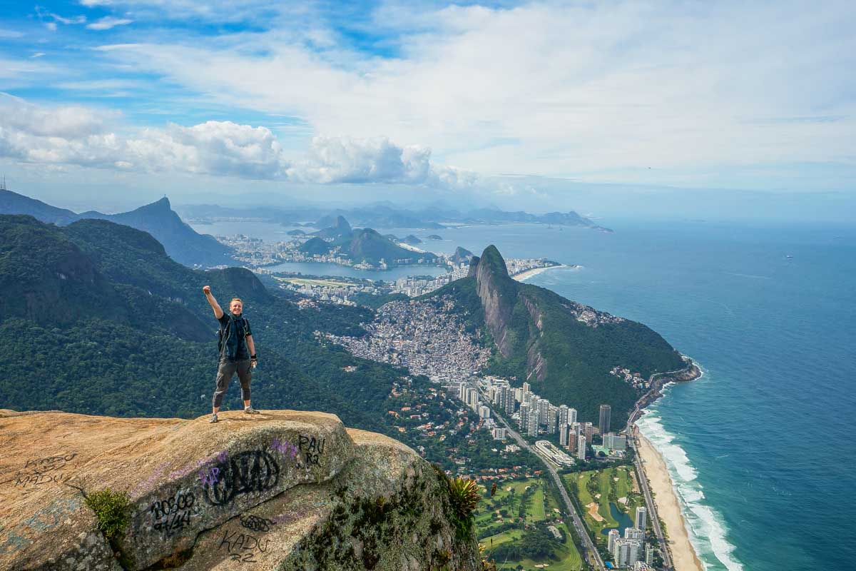 A man stands on the edge of Pedra da Gavea in Brazil