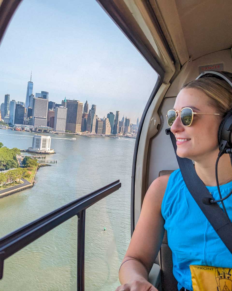 Bailey looks out the windown as we fly over Ellis Island with New York City in the background
