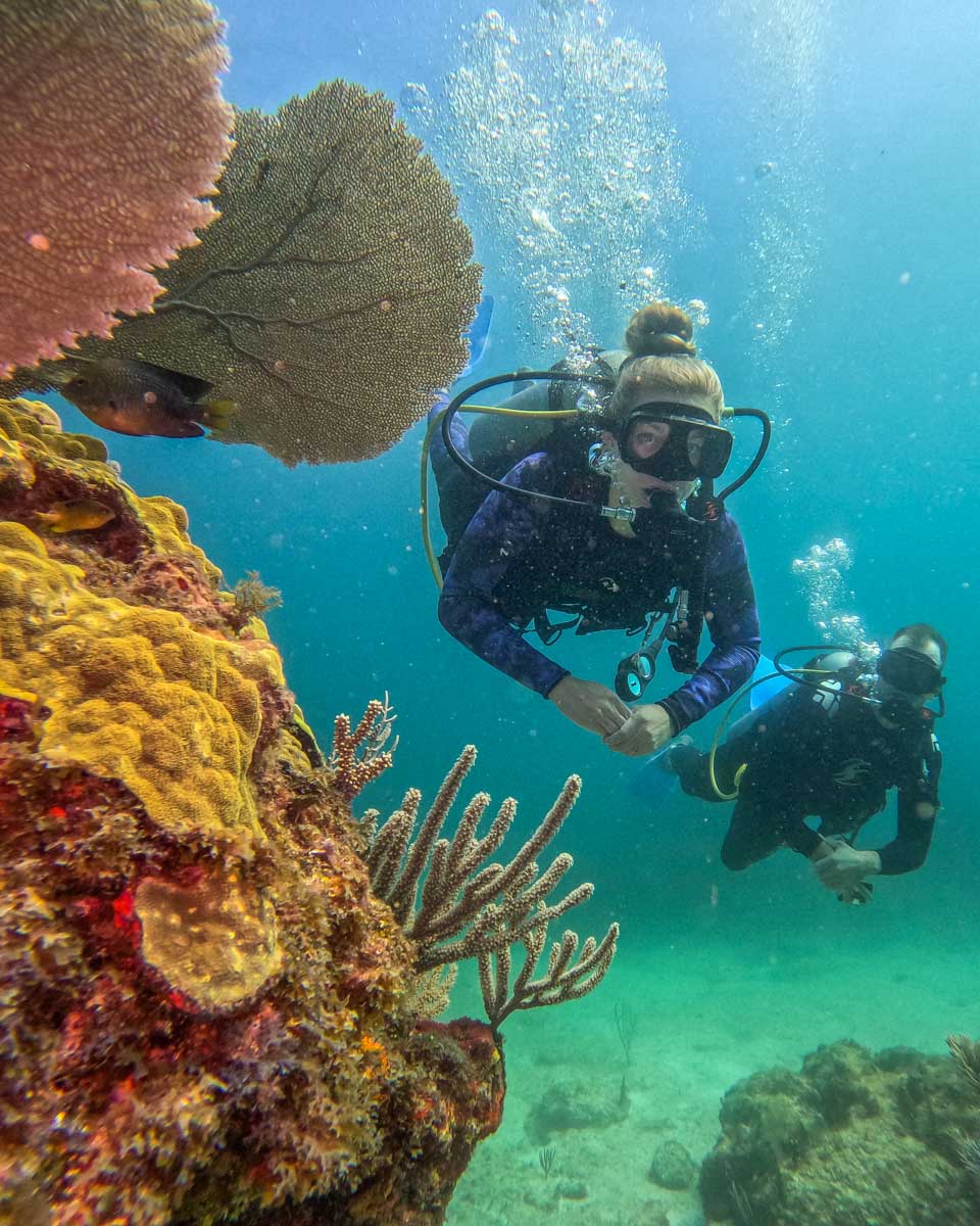 Daniel and Bailey pose for a photo underwater while scuba diving in Puerto Morelos, Mexico