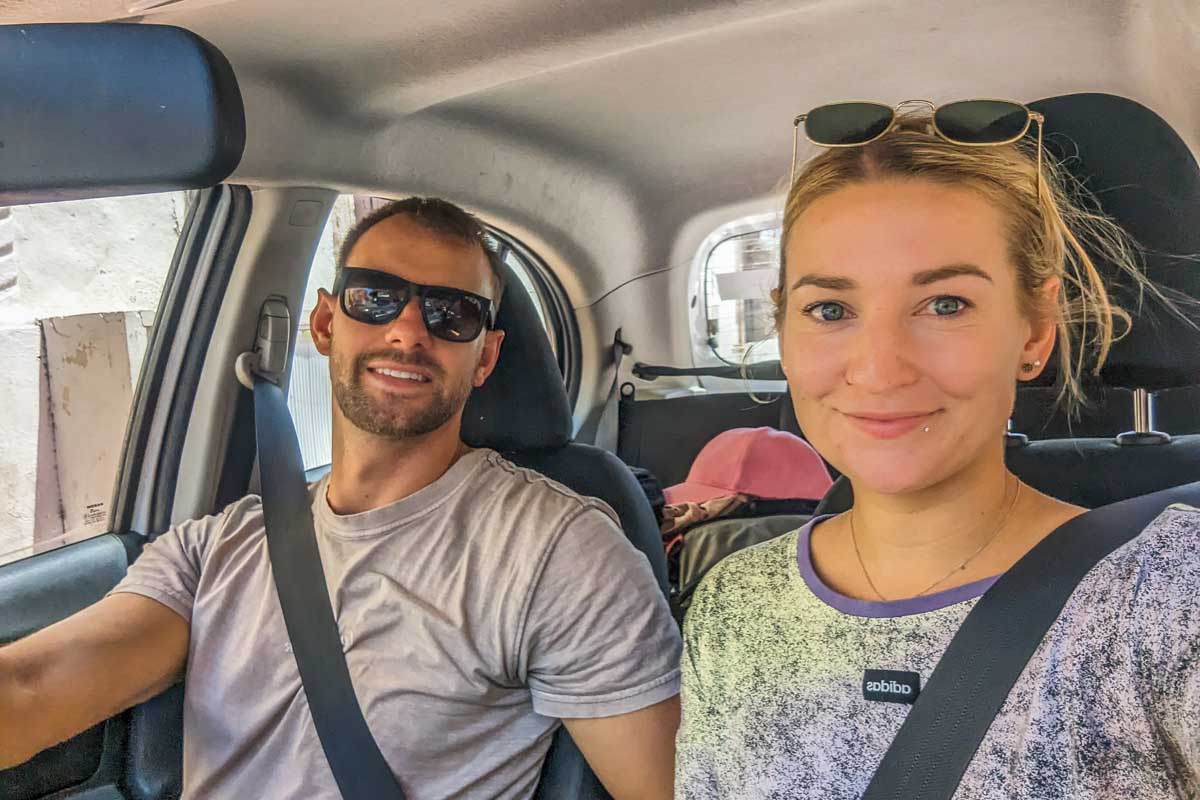 Daniel and Bailey take a selfie driving in their rental car in Mexico