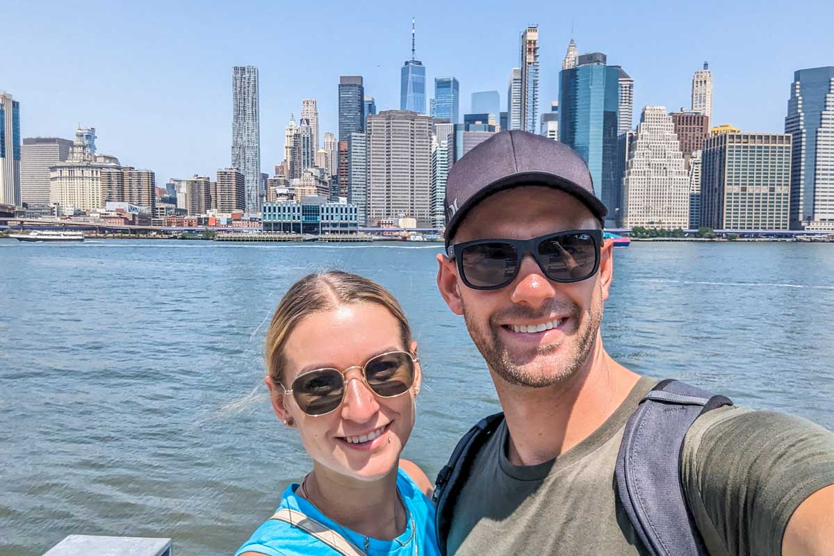 Daniel and Bailey take a selfie in Brooklyn Heights with views of Manhattan in the background