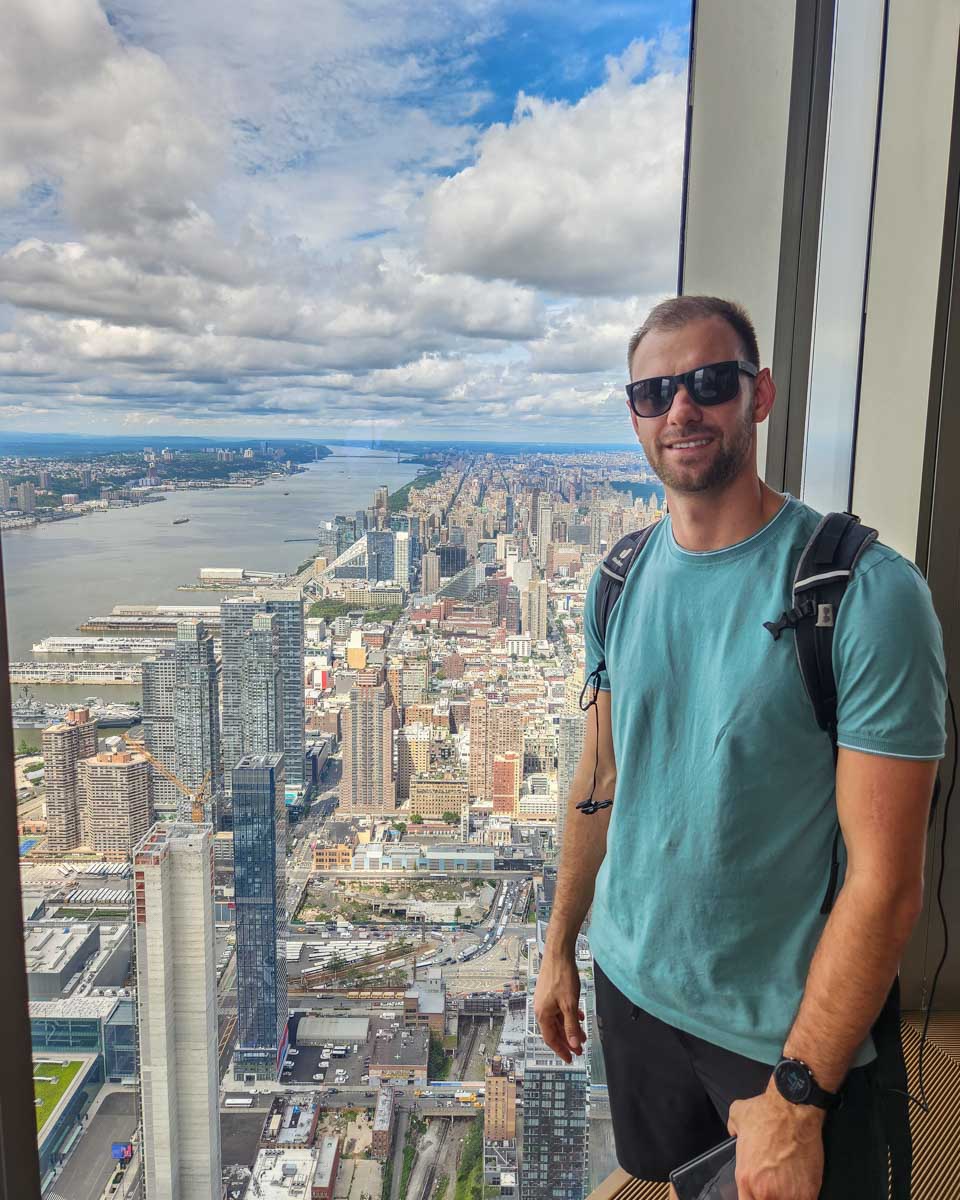 Daniel poses for a photo at a window inside Edge NYC