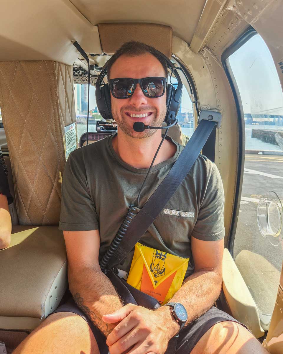 Daniel poses for a photo inside a NYC helicopter about the take off from Manhattan