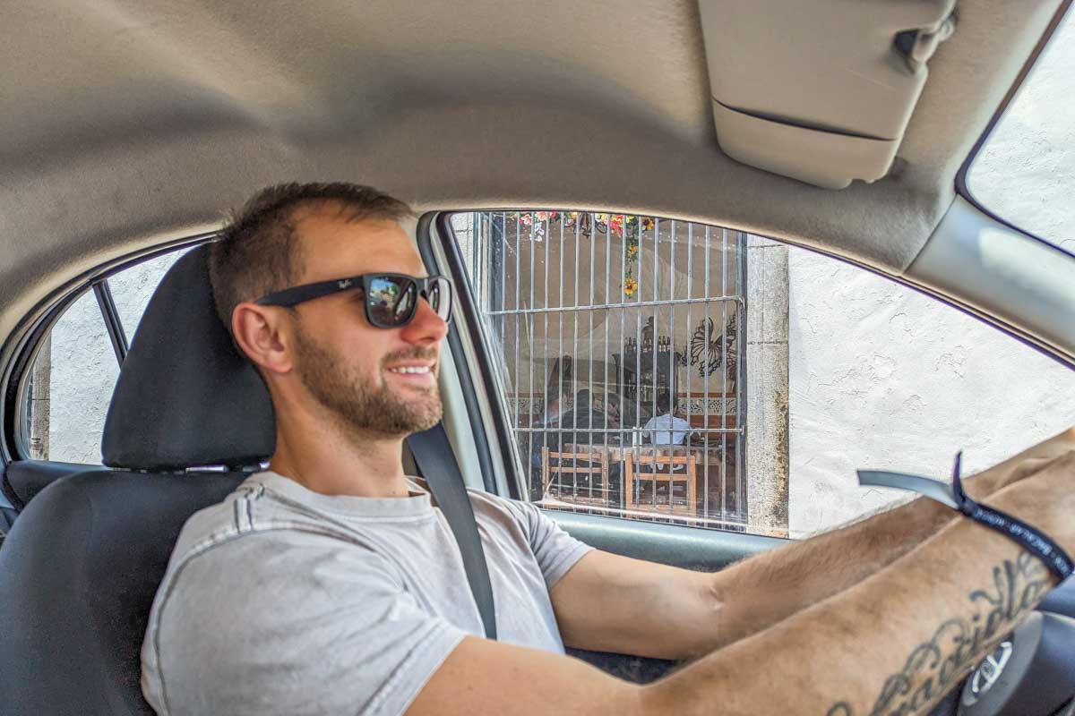 Daniel smiles at the camera while he drives in Mexico