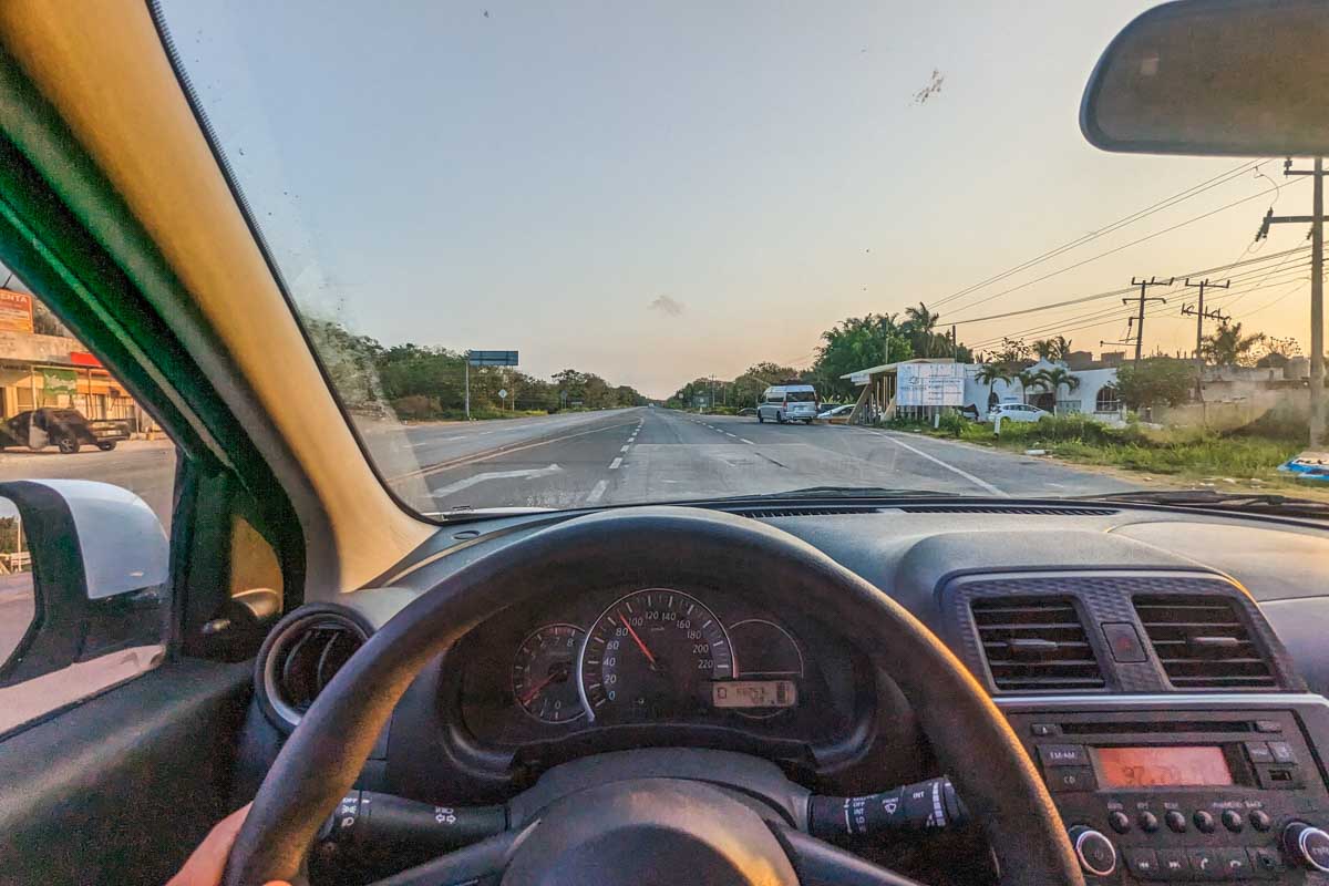 Driving our Mexico rental car at sunset in Mexico