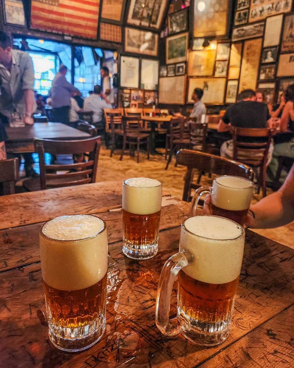 Four beers on a table at McSorley's Old Ale House in New York City